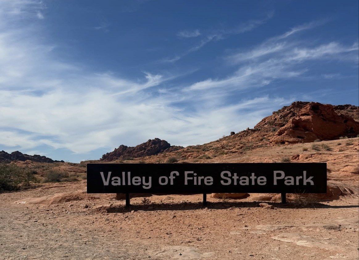 Valley of Fire State Park entrance sign below red hills